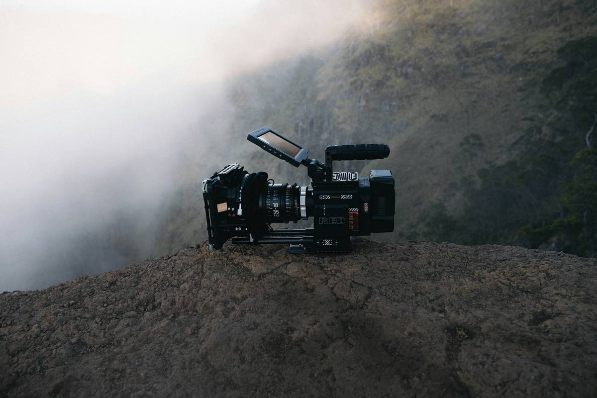 Close-up of lightweight outdoor adventure camera with mountain backdrop